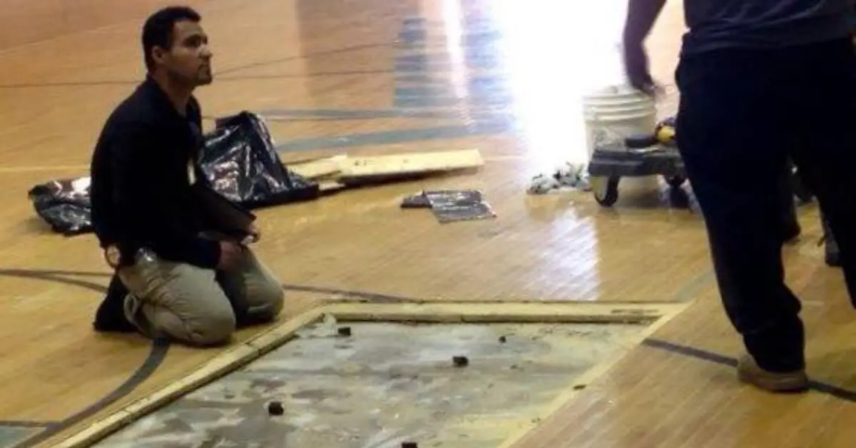 After the School's Flood, Falls to Repair the Gym Floor