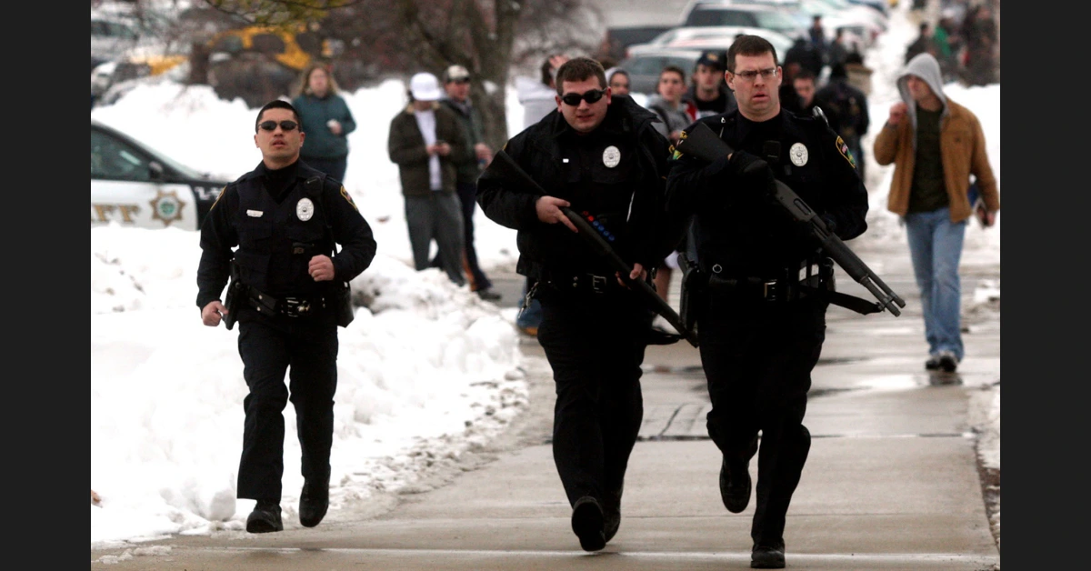 Police officers rush to the scene of the shooting on the Northern Illinois University campus on Feb. 14, 2008.